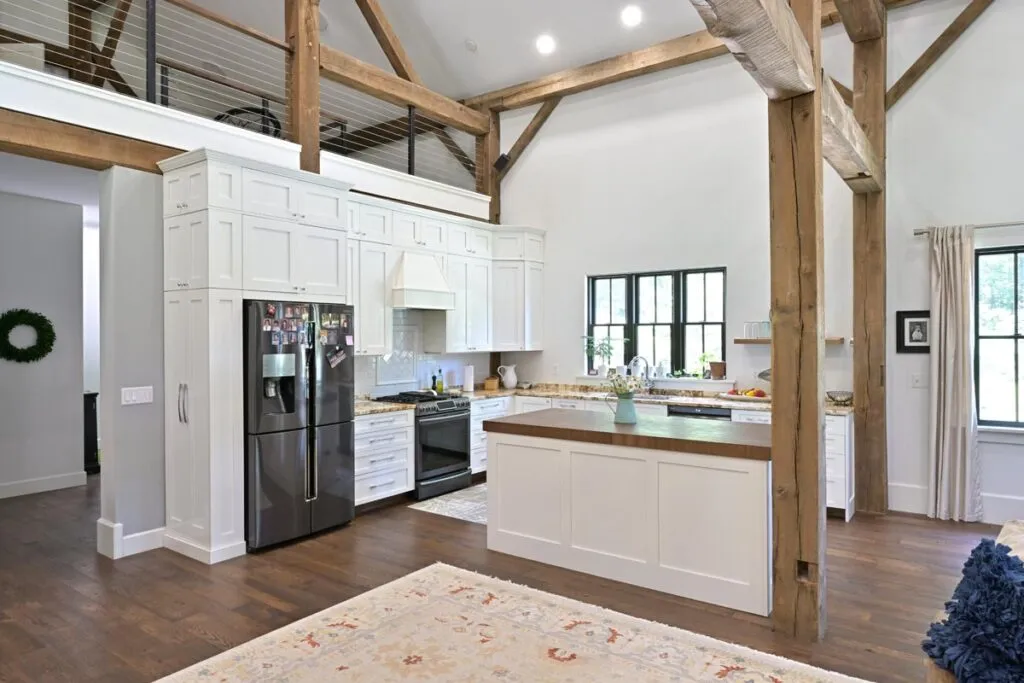 Stone fireplace and reclaimed timber frame detail in the Delaware, Ohio barn home conversion