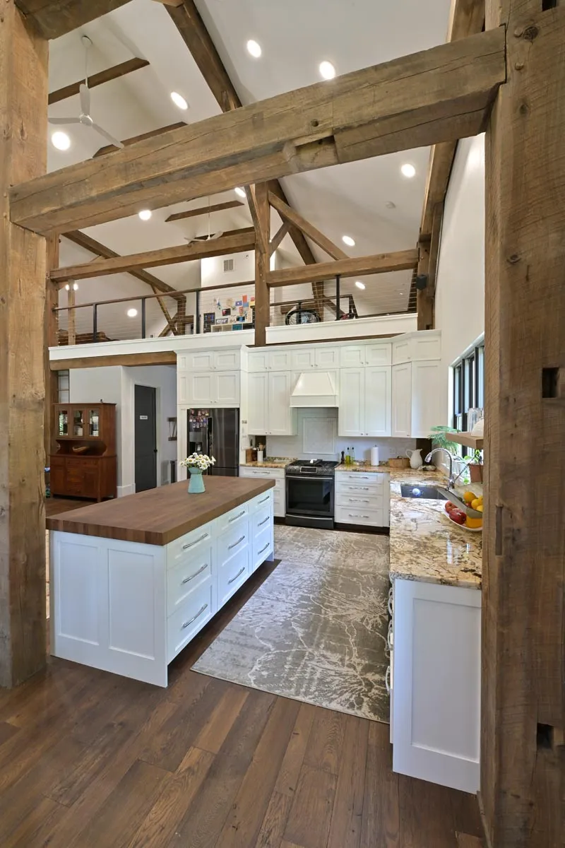 Staircase and loft framed by reclaimed oak timbers in a Delaware, Ohio barn home