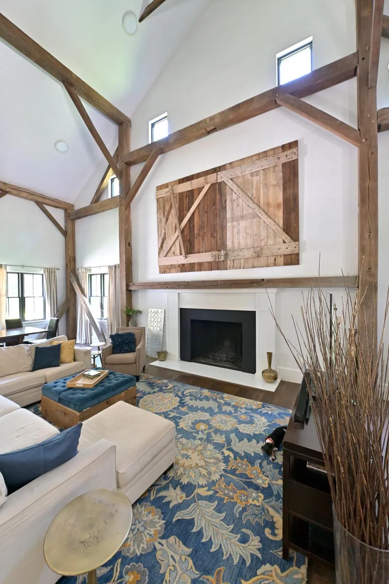 Living room with vaulted ceiling and exposed timber trusses in a Delaware, Ohio barn home