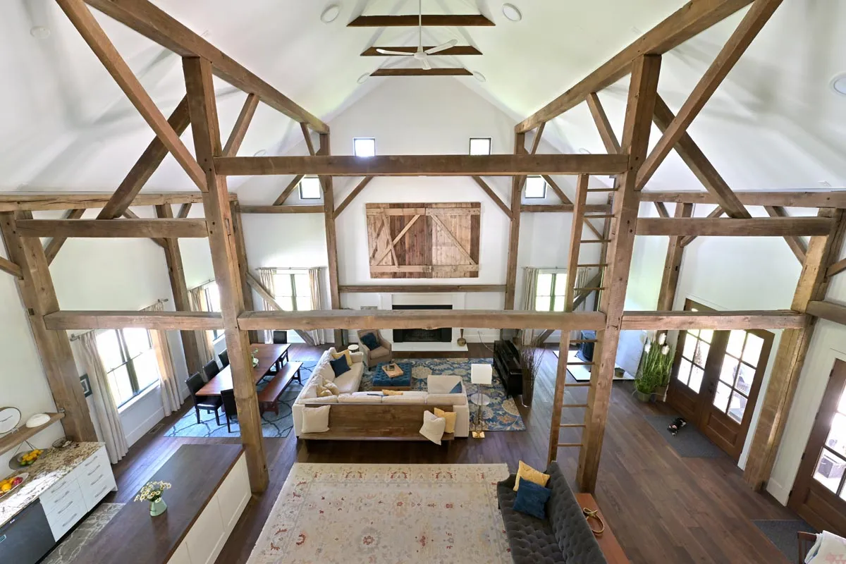 Dining area with reclaimed timber frame and natural light in Delaware, Ohio barn home