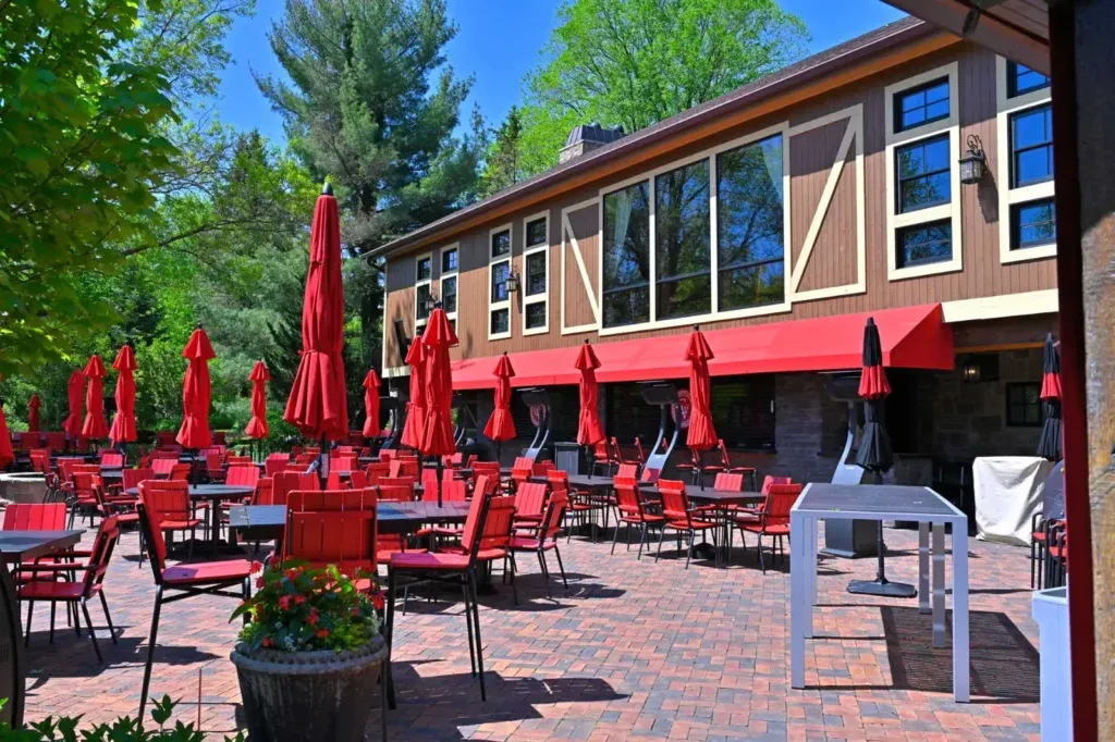Loft dining space with leather seating under the historic timber frame at Gervasi Vineyard in Canton, Ohio