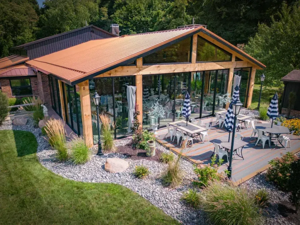 Eastern white pine timbers and inset glass walls of the Hidden Acres Lodge & Winery pavilion in eastern Ohio