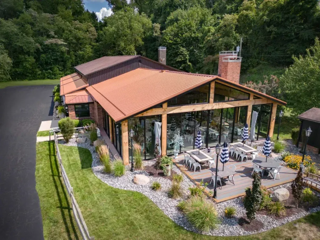 Heavy-timber pavilion addition blending with the natural setting at Hidden Acres Lodge & Winery