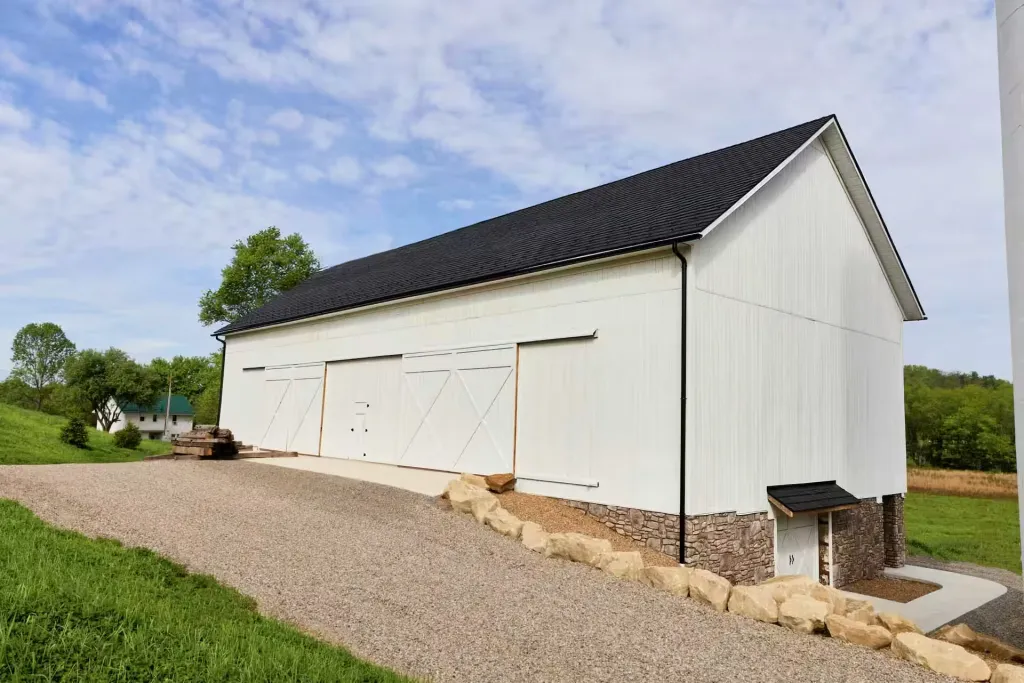 White double barn doors framed by stonework at Mason Farms in Dover, Ohio