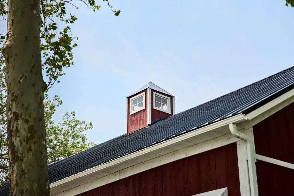 Miller Barn exterior with red hemlock siding, white trim, black metal roof and cupola in Oak Harbor, Ohio