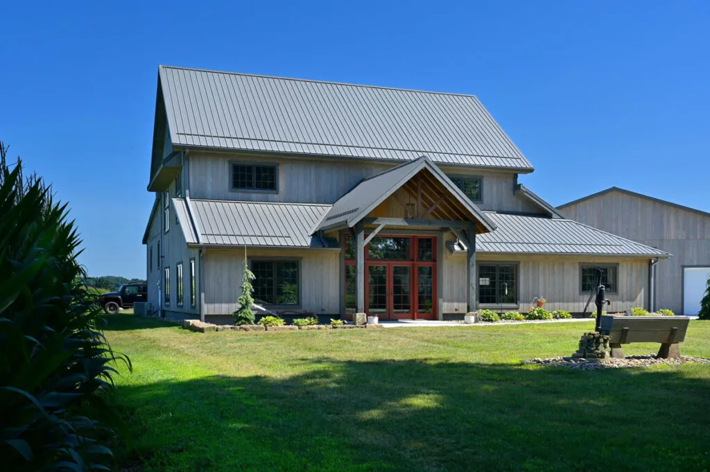 Custom timber frame barn-style home in Newcomerstown, Ohio with metal roof and large front gable entry