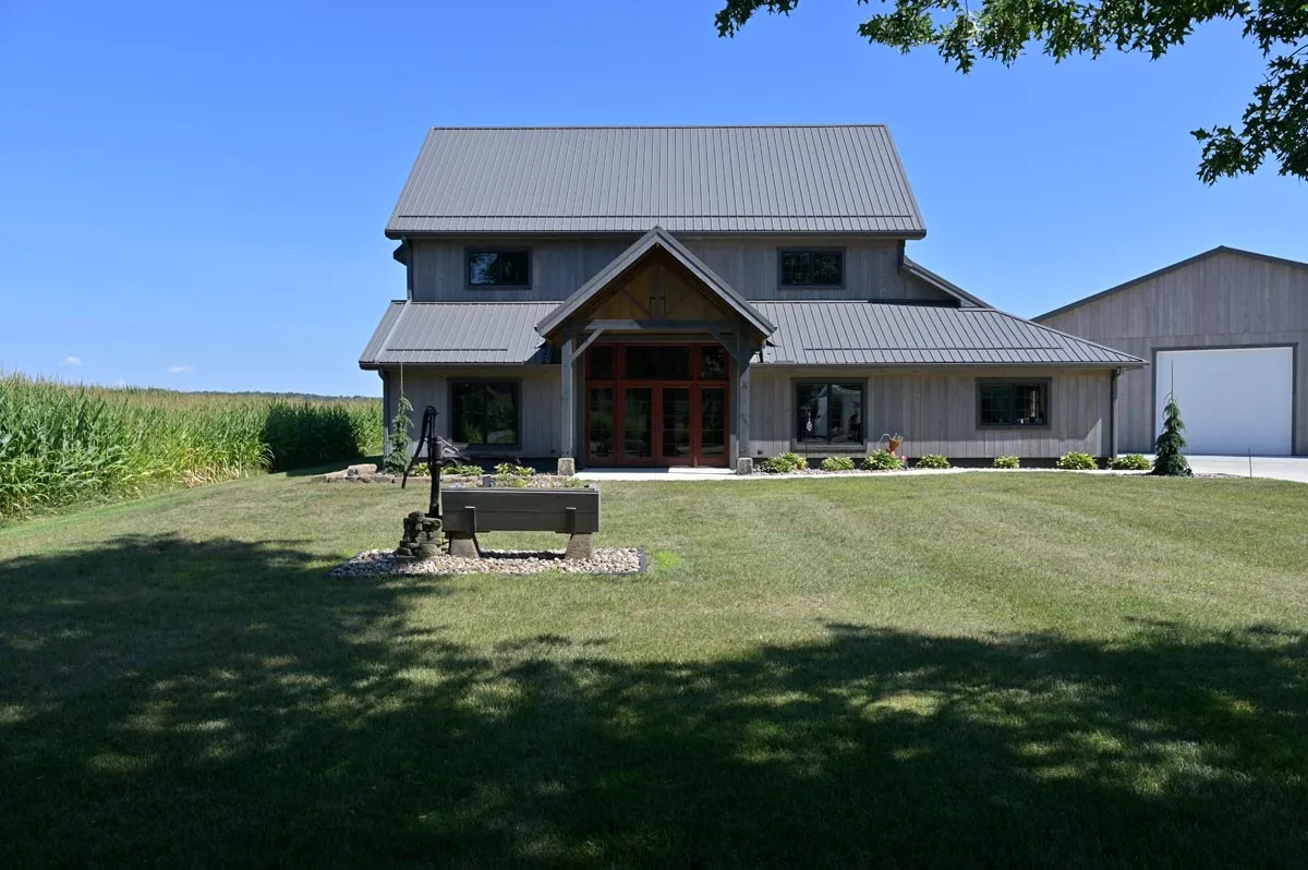 Stained hemlock siding and hip roof of the converted Newcomerstown, Ohio barn home