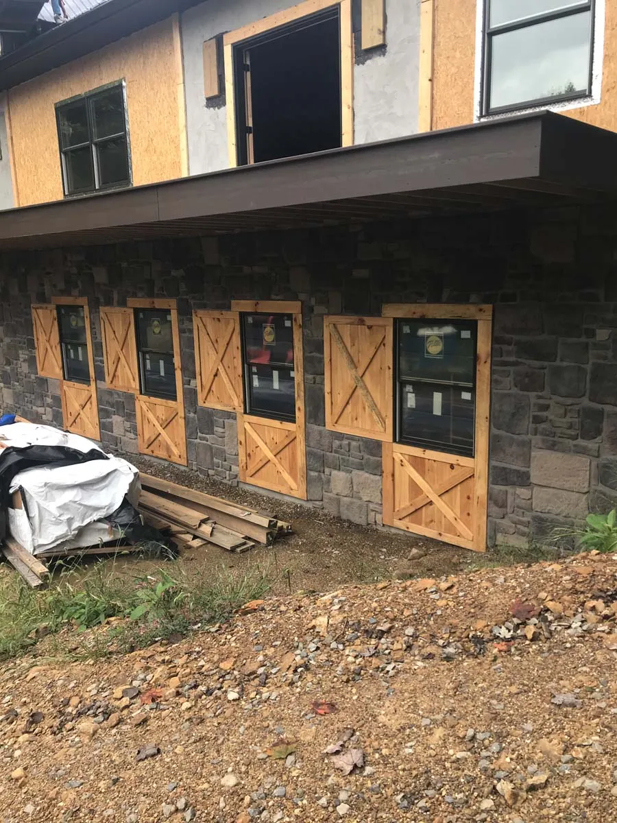 Stone foundation and custom wood barn doors on a restored Ohio timber frame building