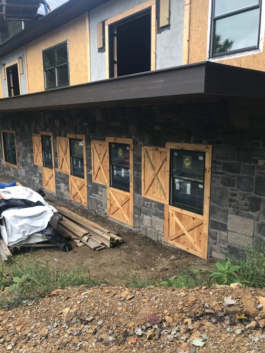 Finished stone foundation with custom wood barn doors on a restored Ohio timber frame building