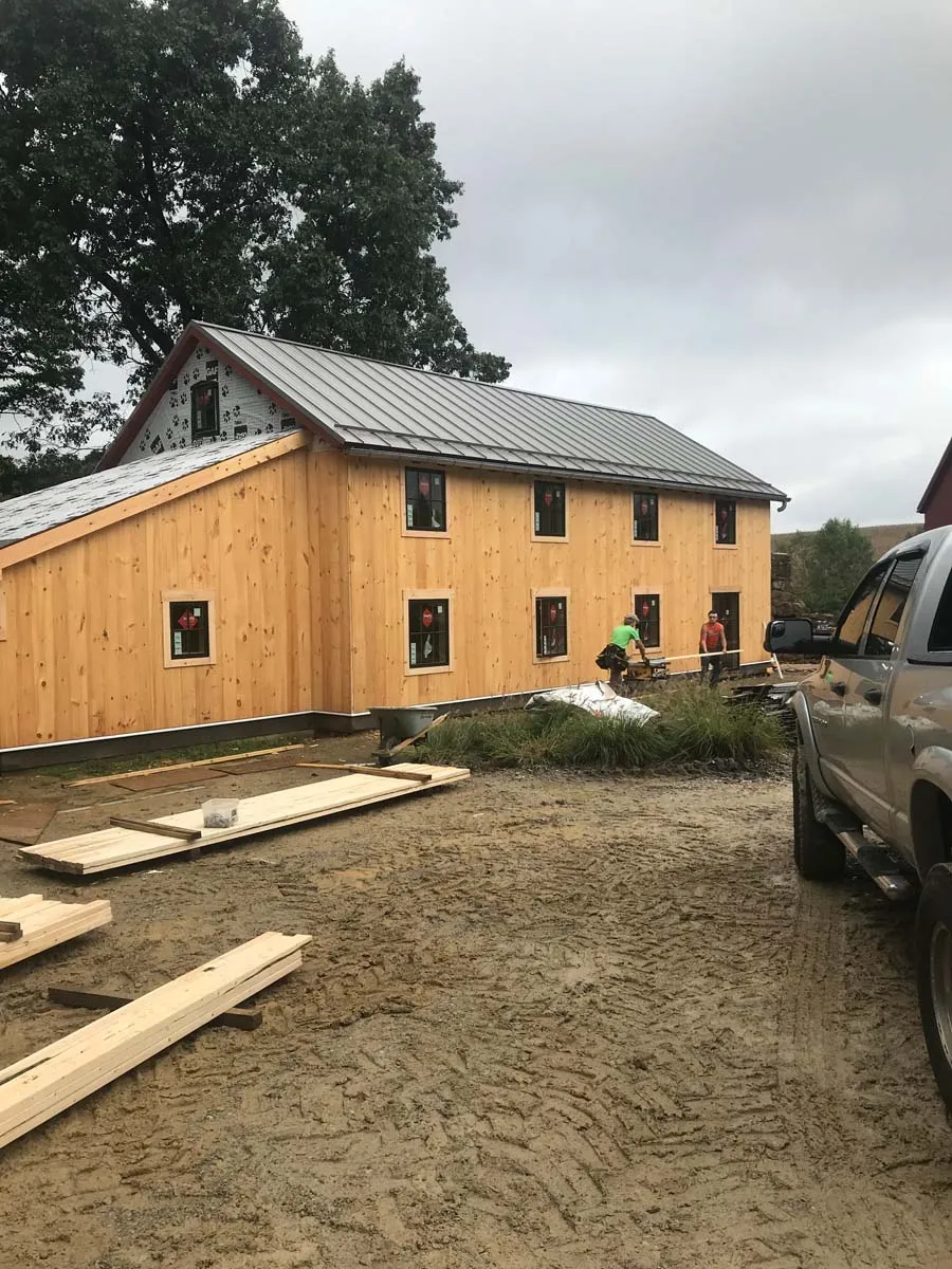 Standing seam metal roof and fresh pine siding installed on an Ohio barn home